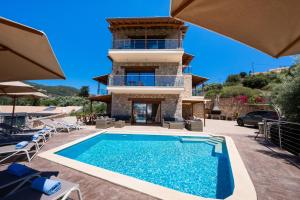 a villa with a swimming pool and a house at 180 Mansion in Mikros Gialos