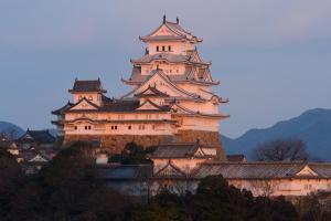 a large castle on top of a mountain at WholeHouse Himeji Castle ホールハウス 姫路 in Himeji