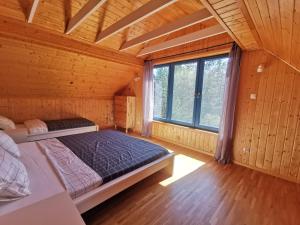 a bedroom with a bed in a wooden room at Leśne Wspomnienia in Niesiołowice +31 photos