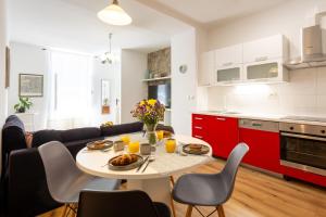 a kitchen and living room with a table and chairs at Fina Apartment in Opatija +24 photos