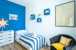 a bedroom with a bed and a chair at Fina Apartment in Opatija