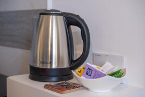 a tea kettle and a bowl on a counter at Casa Olga in San Bartolomeo al Mare
