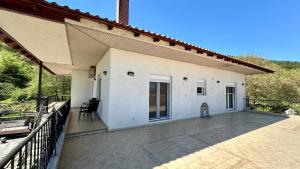 a porch of a house with a patio at Stella's House in Eleftheroúpolis