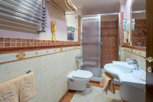 a bathroom with a toilet and a sink and a shower at Hotel Michelangelo in Sorrento