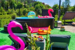 a backyard with a pool with a toy flamingo at GORSKI RESORT Lux Apartments Jacuzzi & Sauna in Poronin