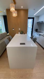 a kitchen with a white island in a living room at Opera Garden in Seogwipo