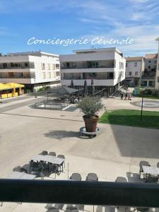 a courtyard with tables and chairs in front of a building at Les Bosquets in Alès +7 photos