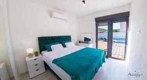 a bedroom with a bed and a view of the ocean at Villa Elysian Blagaj in Blagaj +57 photos