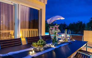 a dining room table with fruits and flowers on it at Villa Maslina in Sikovo