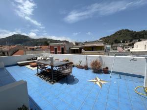 a patio with a table and a star on a roof at Casa Luna in Lipari