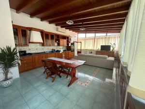 a kitchen with a wooden table and a couch at Casa Luna in Lipari
