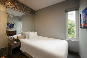 Voodi või voodid majutusasutuse Ping Hotel toas