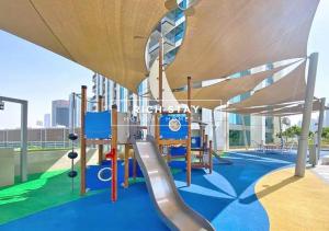 a playground on the roof of a building with a slide at Incredible 1BR apartment, Downtown Views II by Rich Stay in Dubai