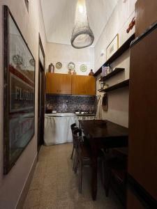 a kitchen with a table and some chairs and a counter at allacasett in Favignana