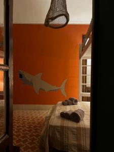 a bedroom with a bed with a fish mural on the wall at allacasett in Favignana
