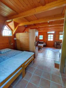 a bedroom with a bed in a wooden cabin at Vineyard cottage Kralj in Uršna Sela