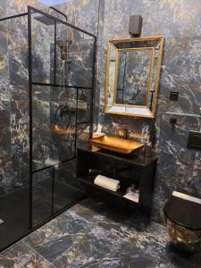 a bathroom with a sink and a mirror at LUX 114 APARTMENT in Košice