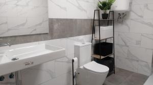 a white bathroom with a sink and a toilet at Casa Samil in Vigo