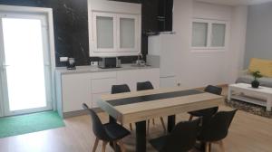 a kitchen with a table and chairs in a room at Casa Samil in Vigo