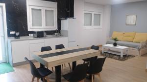 a living room with a wooden table and chairs at Casa Samil in Vigo +20 photos