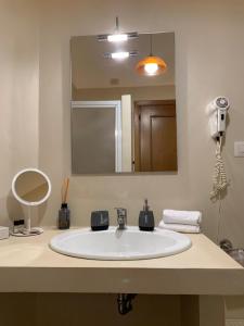 a bathroom with a white sink and a mirror at New Flat Between The Vatican & Piazza del Popolo in Rome