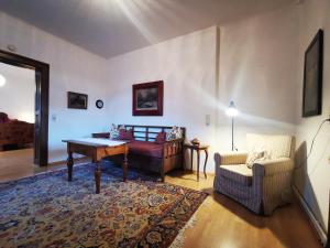 a living room with a table and a couch at Villa Martiny in Seeboden