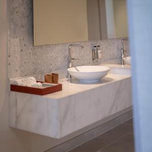 a bathroom with a bowl sink on a counter at Zoya Health & Wellbeing Resort in Ajman 