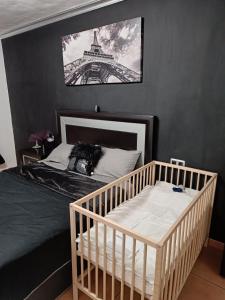 a bedroom with a crib and the eiffel tower at 100 Steps to the Sand. in La Tejita +25 photos