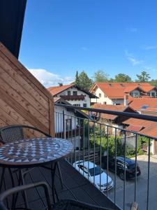 a balcony with a table and chairs and buildings at Hotel Schwaiger in Glonn +68 photos