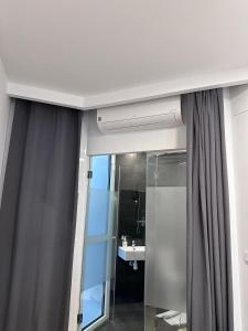 a bathroom with a shower and a sink at LOTUS SUITES Alicante in Alicante