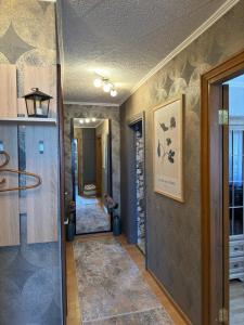 a hallway with a door leading to a bathroom at DREAMSVILLE in Ventspils