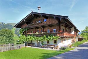 a large wooden house on the side of a road at Haus Boarbauer in Kirchberg in Tirol