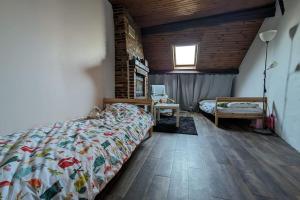 a bedroom with a bed and a table and a window at Douceur de vivre au bord de l'Avre in Chennebrun