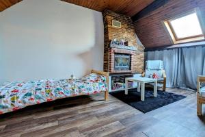 a bedroom with a bed and a fireplace at Douceur de vivre au bord de l'Avre in Chennebrun