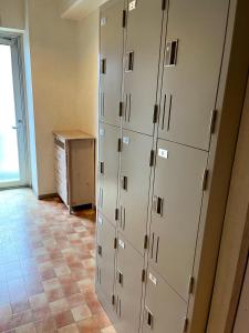 a room with lockers and a dresser in a room at Business Hotel Legato in Tokyo
