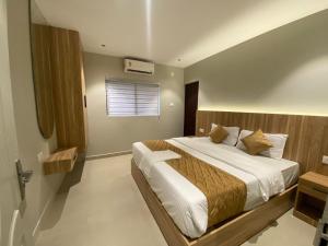 a bedroom with a bed and a window at Muziris Manor Residency in Cochin