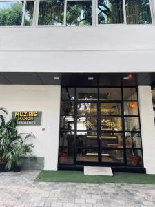 a store front of a building with large windows at Muziris Manor Residency in Cochin