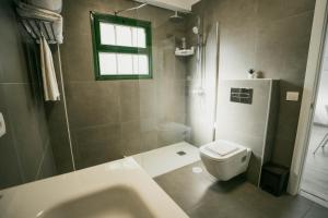 a bathroom with a sink and a toilet and a window at Casa Rural Guadá in Valle Gran Rey +100 photos