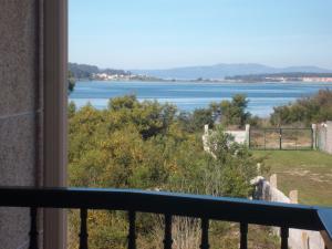 a view of the water from a balcony at Apartamento en A revolta in Sanxenxo