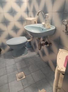 a bathroom with a sink and a toilet at Apartments and Room MV in Petrovac na Moru