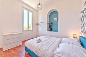 a bedroom with a bed and a window at Maison Martel in Antibes