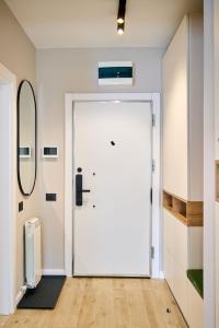 a large white door in a room at Soleil Anne std - Infinity Pool & Spa Resort in Mamaia