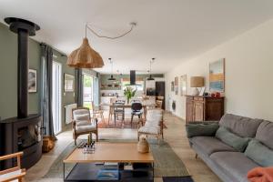 a living room with a couch and a table at La Cabane des Ebihens - A moins d'1km de la plage in Lancieux