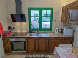 a kitchen with a sink and a window at Casa mar y cielo in Playa Blanca +34 photos