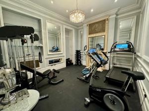 a room with a gym with exercise equipment in it at The Leonard Hotel in London