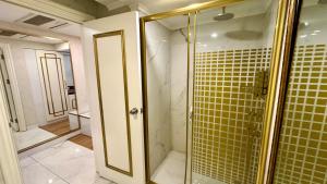 a bathroom with a shower with yellow tile at Burj Al Istanbul in Istanbul +129 photos