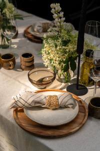 a table with a plate of food and flowers on it at Chalet Boisée in Voorthuizen