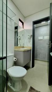 a bathroom with a toilet and a sink at Studio Flat Tramonto in João Pessoa