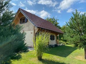 a small house in a yard with trees at Loghouse Brunka - Escape from life on a highway in Gornja Radgona