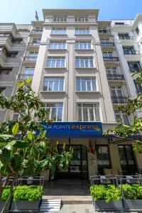 a large white building with a sign on it at Four Points Express by Sheraton Istanbul Taksim Square in Istanbul